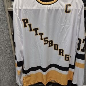 Pittsburgh Penguin Crosby Hockey Jersey and San Jose Sharks Celebrini Jersey.